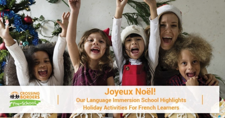 A cheerful group of children and a teacher celebrate together, expressing joy in front of a decorated holiday backdrop.