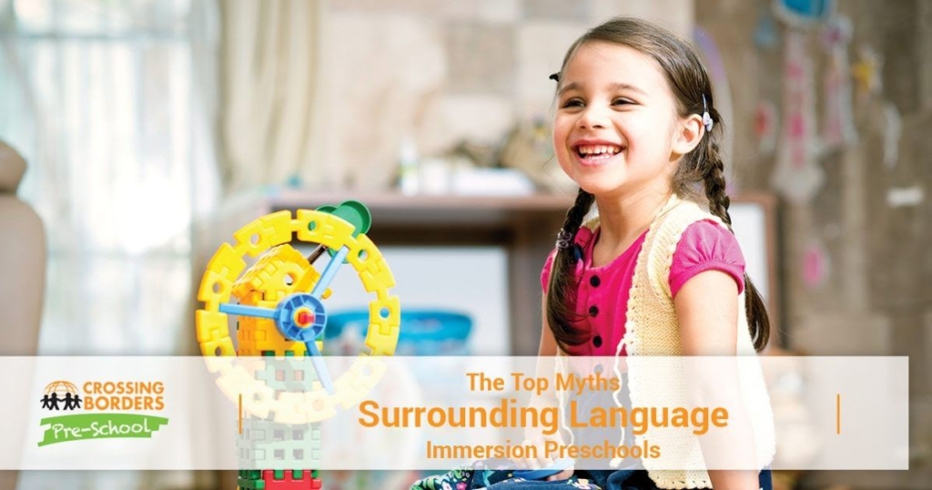 A smiling girl in a pink shirt enjoys playtime, with a colorful toy in the background, radiating happiness and joy.