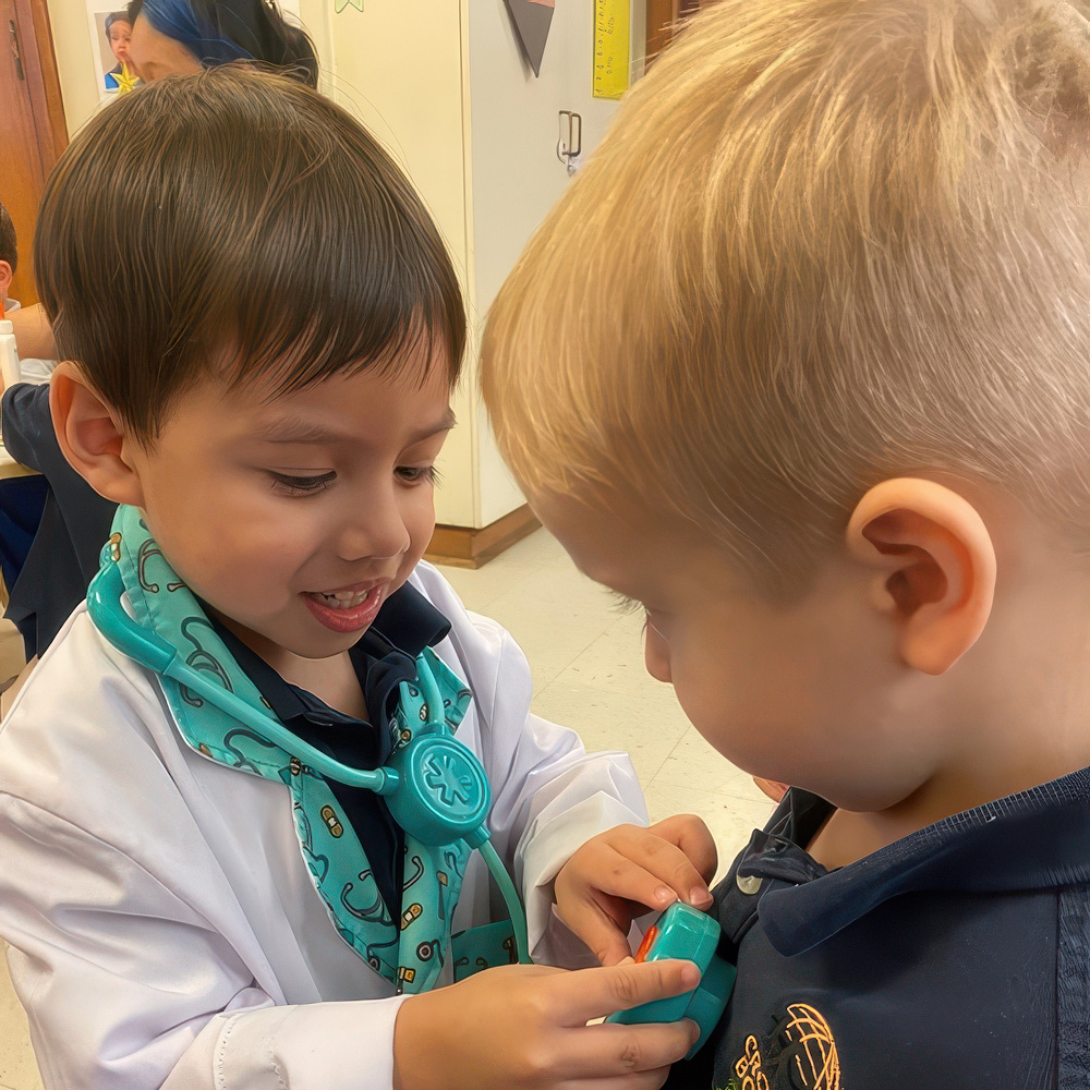 Two children playfully interact, with one in a white coat using a toy stethoscope on the other, creating a fun moment.